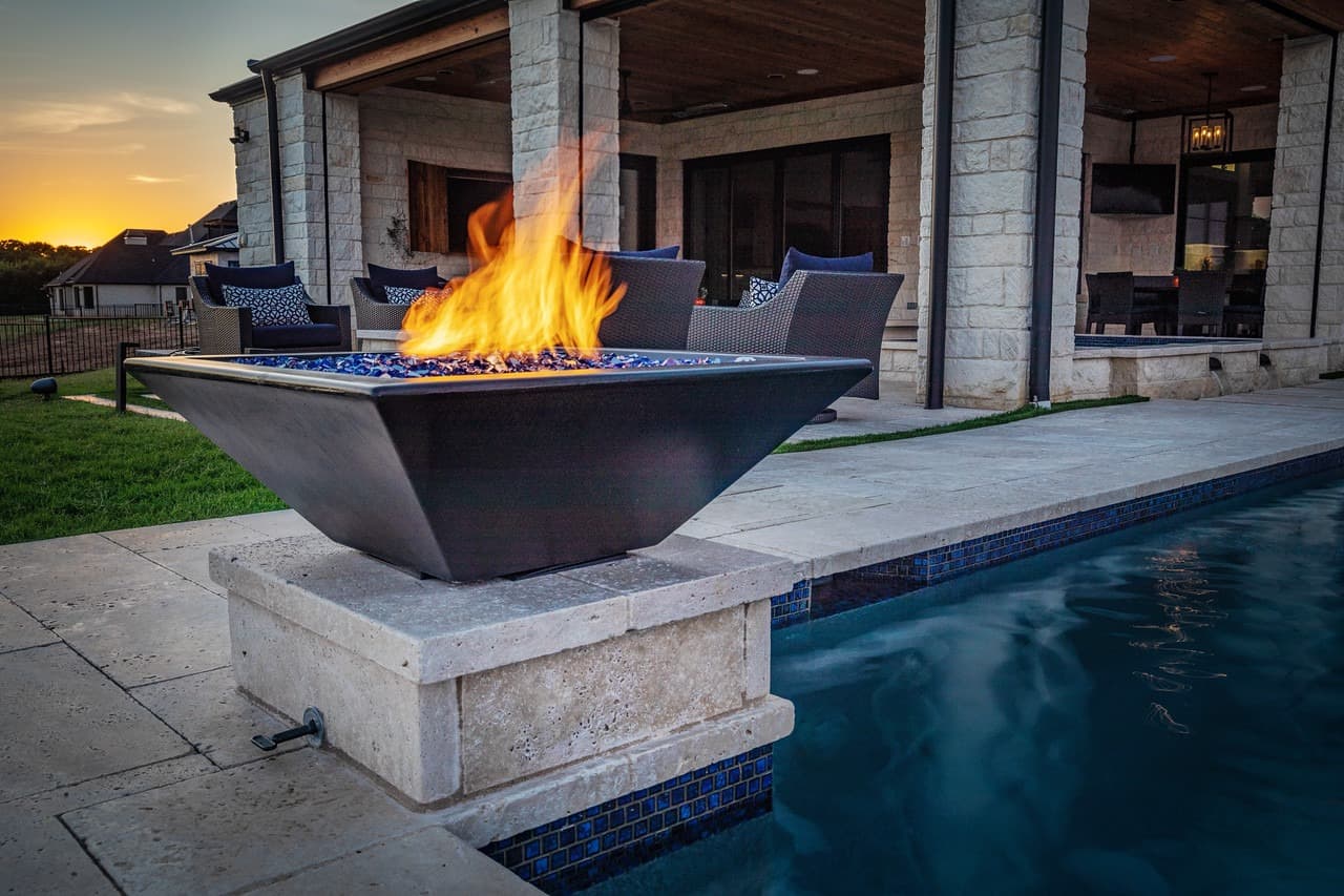 Fire bowl with active flame in outdoor living space